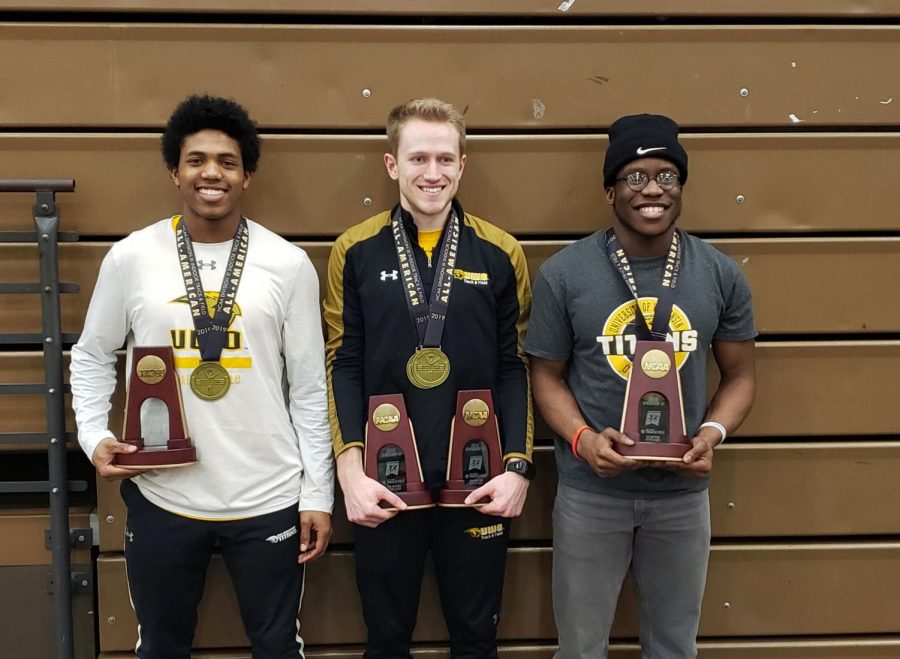 FROM LEFT TO RIGHT: Freshman Johnathan Wilburn, senior Ryan Powers and sophomore Robert Ogbuli pose with their All-American recognition medals and event trophies.