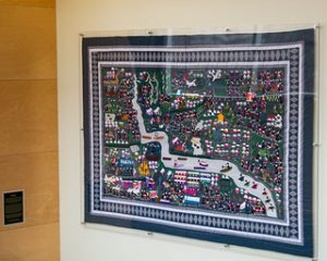 Paj Ntaub, a Hmong story cloth, is displayed. The cloths document daily experiences and hardship.