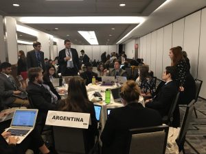 group of MUN students sits around a table discussing topic issues