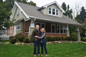 UWO alumni Josh and Alli (Kerwin) Hughes happily pose in front of their new Waukesha home.