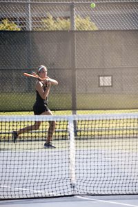 Junior Alyssa Leffler returns a ball over the net in Sunday’s home match against Cathage College.