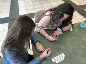 Maddie Nolan and Savanna Peterson write supportive messages for sexual assualt awareness. 