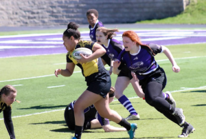 Titan forward carries the ball through UW-Whitewater defenders. UWO split their team in two and took first and second.