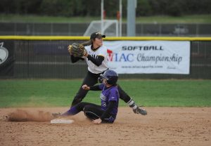 Natalie Dudek avoids a sliding UW-Whitwater baserunner in an attempt to turn a double play.