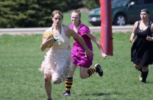 Rugby players playing in prom dresses