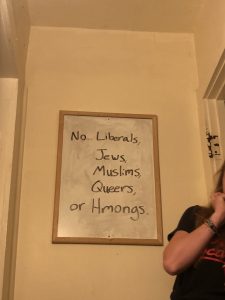 Whiteboard reads "No... Liberals, Jews, Muslims, Queers or Hmongs"