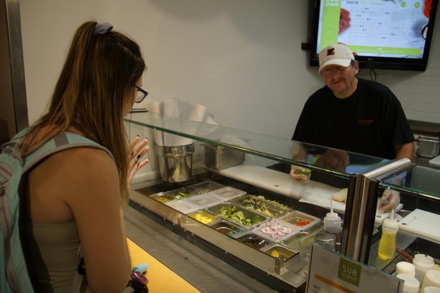 An A’viands employee makes a sub for a UW Oshkosh student at the newly named “Sub Stand” at Reeve Union.