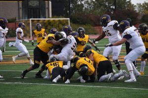 A host of UW Oshkosh defenders tackle UWSP running back ShamaJ Williams during the Titans’ 20-7 victory on Saturday.  UWO will face UW-Eau Claire next game in the team’s homecoming game.