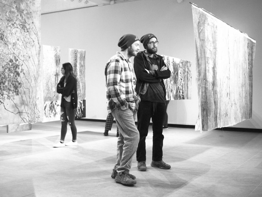 Students view Hunder’s exhibition at the gallery’s reception last Thursday night.