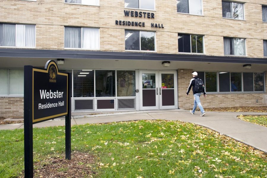 A student walks into Webster Residence Hall on High Avenue at UW Oshkosh.
