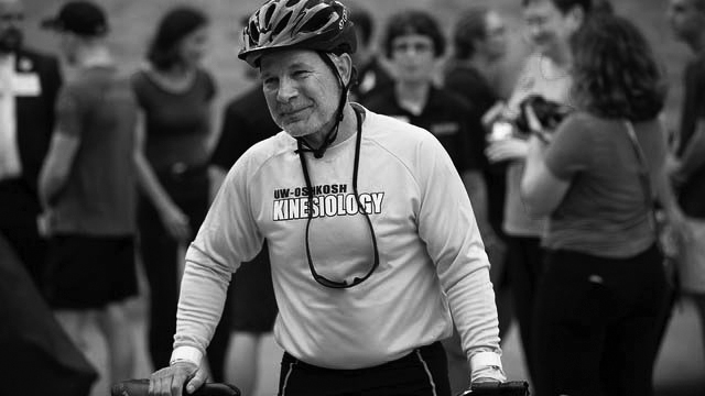 Kinesiology+professor+Dan+Schmidt+arrived+at+UW+Oshkosh%E2%80%99s+Opening+Day+festivities+via+police+escort+after+riding+his+bicycle+across+the+state+in+support+of+student+scholarships.