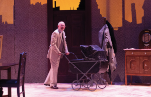 Chris Flieller, who plays a grown Vincent, wheels an empty stroller onto stage
