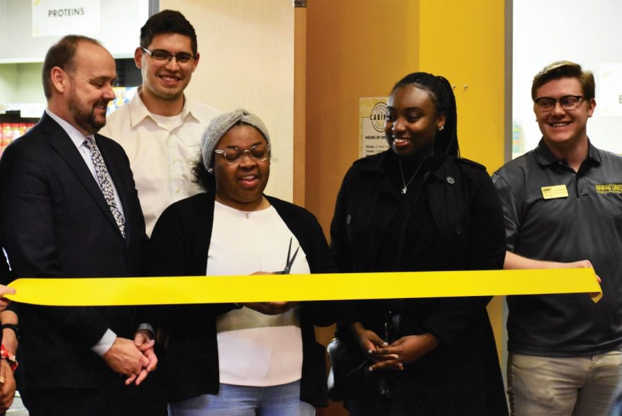 The Cabinet’s Student Director Joy Evans prepares to cut a ribbon at the food pantry’s opening ceremony. Chancellor Leavitt and Karen Walsh, a member of the UW System Board of Regents, both spoke at the event.