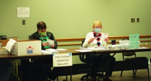 April Lee / Advance-Titan — Poll workers in Oshkosh kept busy in April with absentee ballots.