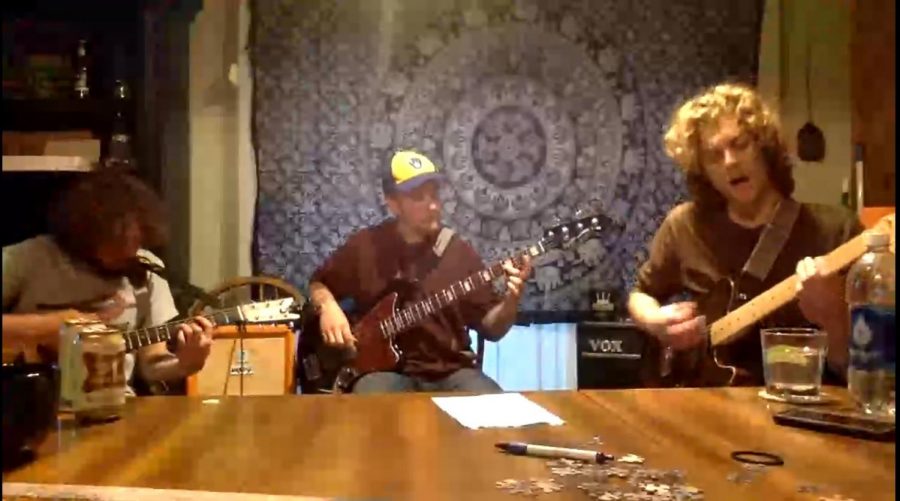 From left to right, Daniel Saxes, David Stevens and Mike Stevens perform songs from their album “Ted’s Basement” in Saxes’ kitchen. 