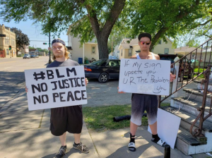 Kailtyn Scoville / The Advance-Titan — Trevor Hansen, left,  and Christian Leiske stand outside Leiske’s house on Ohio Avenue protesting for Black Lives Matter.

