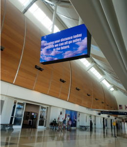 Kaitlyn Scoville / The Advance-Titan — Signs in airports remind travelers to social distance.
