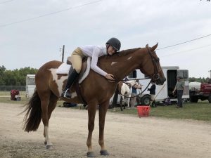 Emma Shodis embraces her horse at a competition at Kenosha County Fairgrounds.