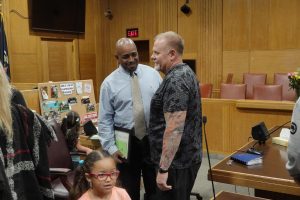 Myron Batiste chats with Winnebago County Court Judge Scott Woldt at his Drug Court graduation. Batiste has become a strong advocate for those battling drug addiction.