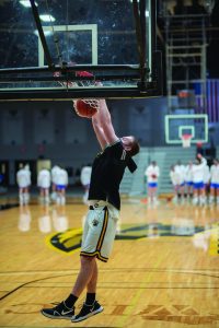 April Lee / Advance-Titan | Freshman center Joseph Adamson slams the ball in warm-ups before the Titans’ 77-68 win over the Pioneers in the Feb. 5 matchup
at the Kolf Sports Center. 