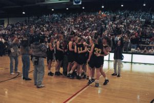 Players celebrating their win against Mount Union in the final game of the 1996 NCAA Division III Womens Basketball Championships. (Courtesy University Archives)