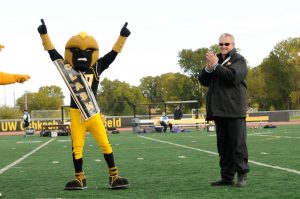 Then Chancellor Richard Wells announces the name chosen in a contest for the new Titan mascot, Clash, during the 2009 Homecoming game. (University Archives)