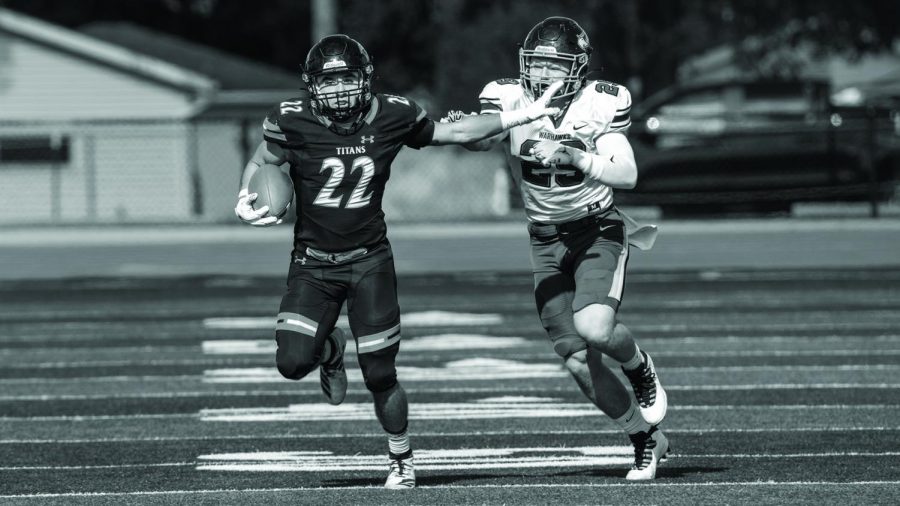 Courtesy of UW Oshkosh Athletics
Peter MacCudden tears down the field to evade UW Whitewater’s number 29. This loss marks the first home game in nearly two years.