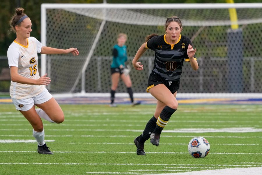 Photo courtesy Terri Cole — Alexia Poulos tears down the field, keeping the ball away from UW-Eau Claire.