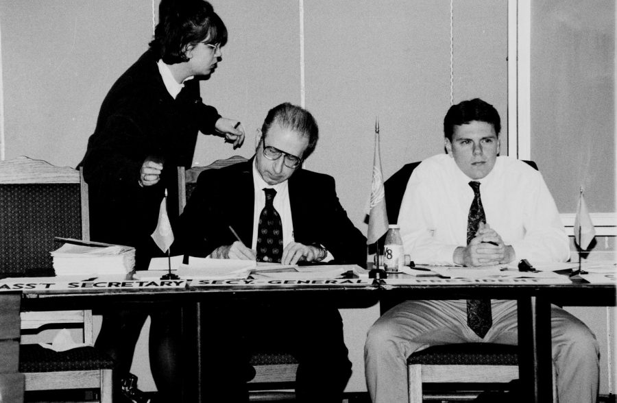 University Archives - Kenneth Grieb (center) sits with students at a Model UN competition.