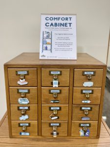 The Oshkosh Public Library and the Day by Day Warming Shelter collaborated to create a Comfort Cupboard in a repurposed card catalog.