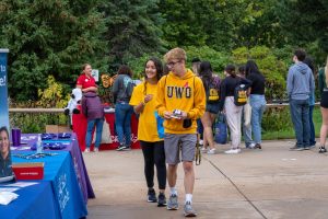 Photo: UWO Flickr — UW Oshkosh students check out some tables at the 2021 Taste of UW Oshkosh. In 2022, the event has been rebranded as Titan Fest and includes games, food and more,