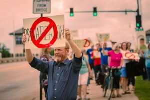 Photo: Charlie Bruecker / The Advance-Titan — Jon Shelton, professor of democracy and justice studies at UW-Green Bay and vice president of Higher Education of the American Federation of Teachers-Wisconsin, joined the Tuesday protest at UW Oshkosh.