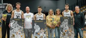 Morgan Feltz / The Advance-Titan — Seniors Levi Borchert, Hunter Plamann and and Eric Peterson pose with their families during Senior Day at the Feb. 11 game.
