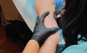 Aubrie Selsmeyer / The Advance Titan - Aubrie Selsmeyer gets a tattoo of heart-shaped balloons by artist Raesha Nordwig, owner of Blush LLC tattoo and piercing shop.