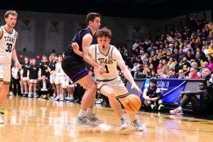 Jacob Link / Advance-Titan -- UWOs Will Mahoney drives on a Fontbonne defender in the NCAA tournament March 3.