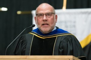 Photo: UWO Flickr — Provost John Koker at a 2017 UW Oshkosh graduation ceremony.