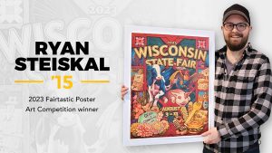 Courtesy of UW Oshkosh -- UWO alumnus Ryan Steiskal stands with his first-place poster. Steiskal recently won the Wisconsin State Fair poster contest for the second time in the last four years.
