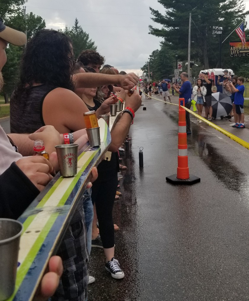 Courtesy of Michelle Waldrop — 
Nearly 1,200 participants prepare to take a shot of Fireball whiskey to set the record for the world’s longest shotski at a bar in Eagle River Aug. 20, 2022.