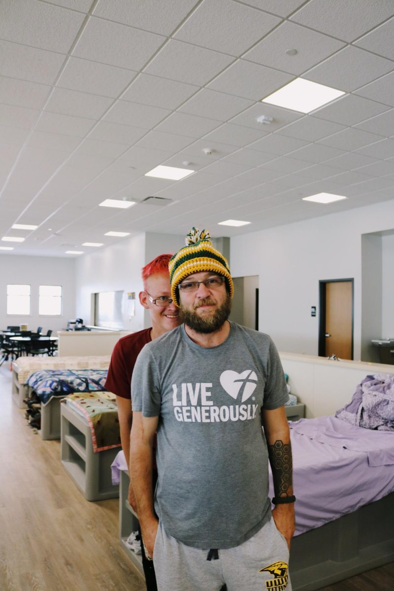 Aubrie Selsmeyer / Advance-Titan - Ben Bernier (front) and Brianna Zarling (back) are both guests at
Day by Day homeless shelter. Ben Bernier (37) is wearing a Packer
hat he crocheted himself. He is self taught and passes his time
making clothing items from yarn for other members of the shelter,
staff and children of staff members.