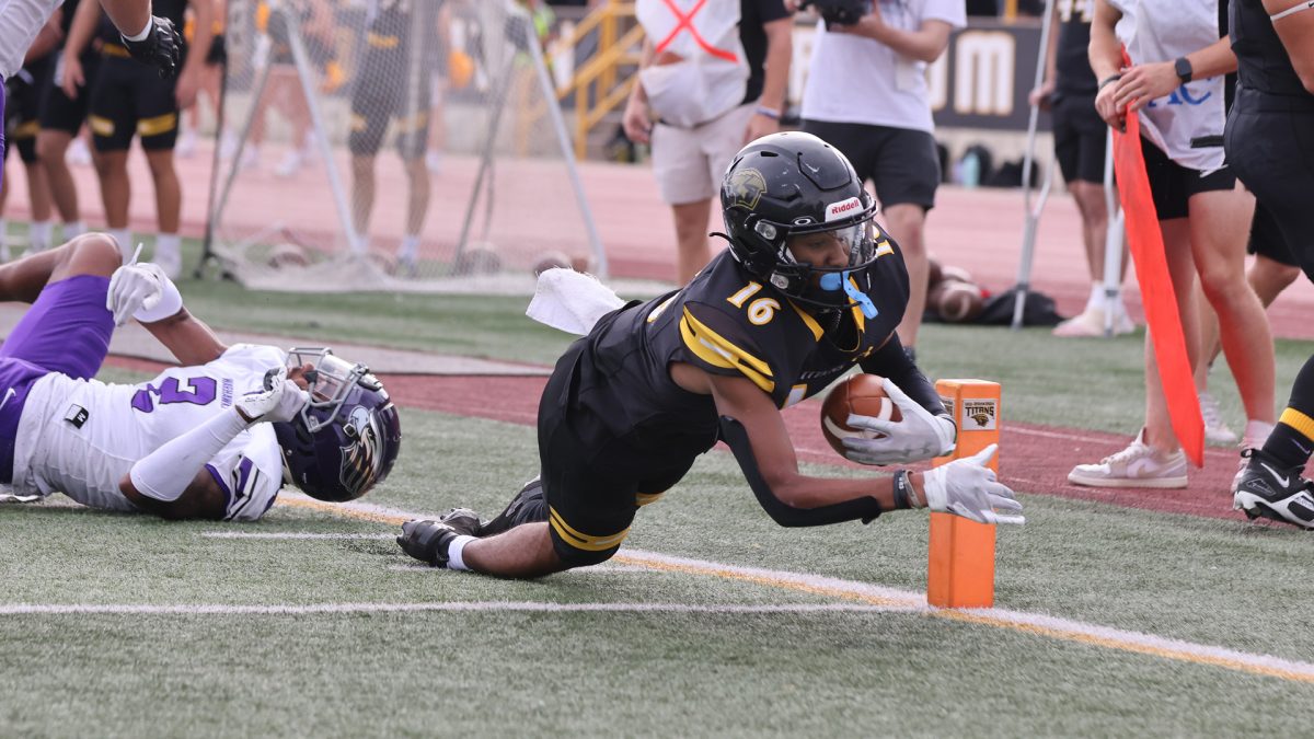 Courtesy of UWO Athletics -- UWOs Trae Tetzlaff dives for the pylon against UWW. Tetzlaff recorded 43 yards and two touchdowns against the Warhawks.