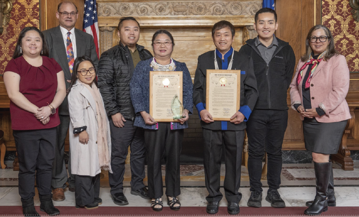 Courtesy of Lori Palmeri — Mee Yang (left center) and Lee Yang (right center) hold their 2023-24 Hometown Hero awards. The Yangs were recognized by Wisconsin representatives Michael Schraa (back left) and Lori Palmeri (far right).