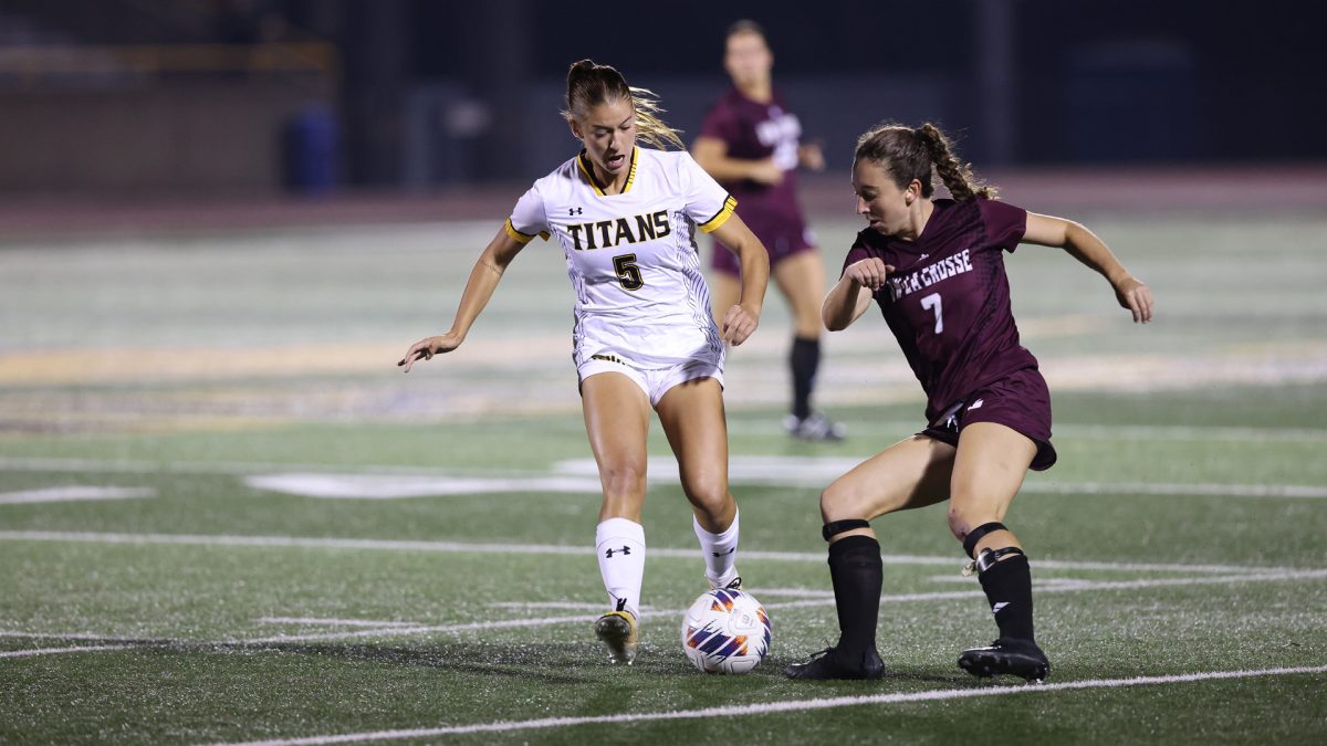 Courtesy of UWO Athletics -- UWO forward Alayna Clark dribbles down the field while being pursued by a UWL player Sept. 30 at J.J. Keller Field at Titan Stadium.