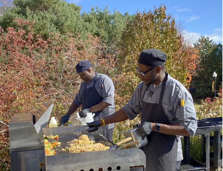 Carlos Hackett (back) and Brandon fair cooking the stir fry that was served at UW Oshkoshs Feel Good Friday on October 20th.