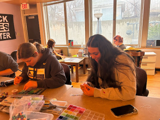 Olivia Porter / Advance-Titan
Students Katie Castelli and Hannah Lanphear make beaded artwork at Crafts, Coffee and Community at the Women’s Center.