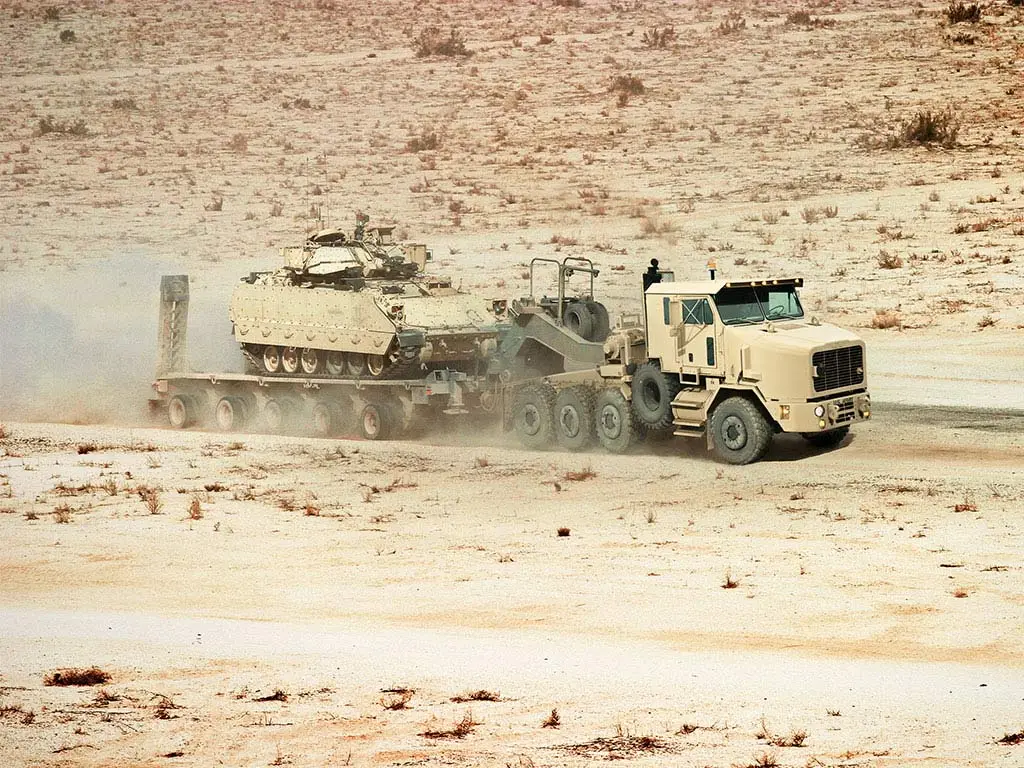 Oshkosh Defense’s Heavy Equipment Transporter A1 tractor transports a tank in the desert