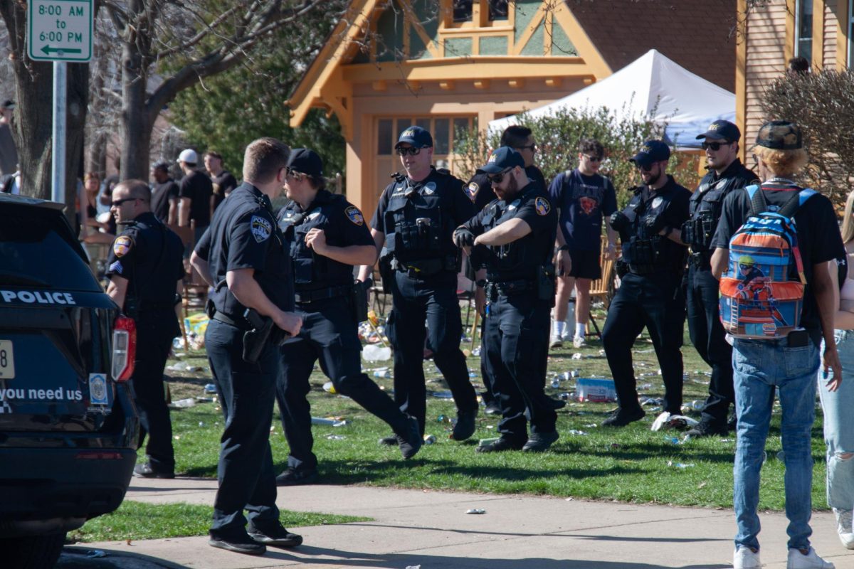 Oshkosh Police Department officers investigate a party on Amherst Avenue during the spring edition of Pub Crawl. 