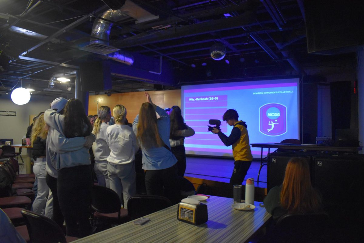 Jacob Link / Advance-Titan -- The UW Oshkosh women's volleyball team celebrates at Titan Underground at the Reeve Memorial Union after hearing its named called as an at-large bid into the NCAA Division III Volleyball Tournament.