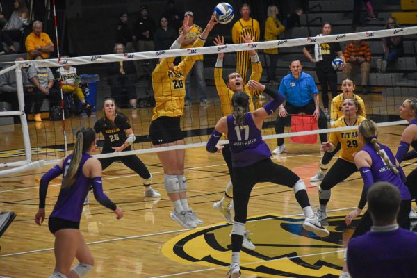 Isaac Pischer / Advance-Titan -- Two Titans jump up for a block against UW-Whitewater in the WIAC Championship game Nov. 16 at the Kolf Sports Center.