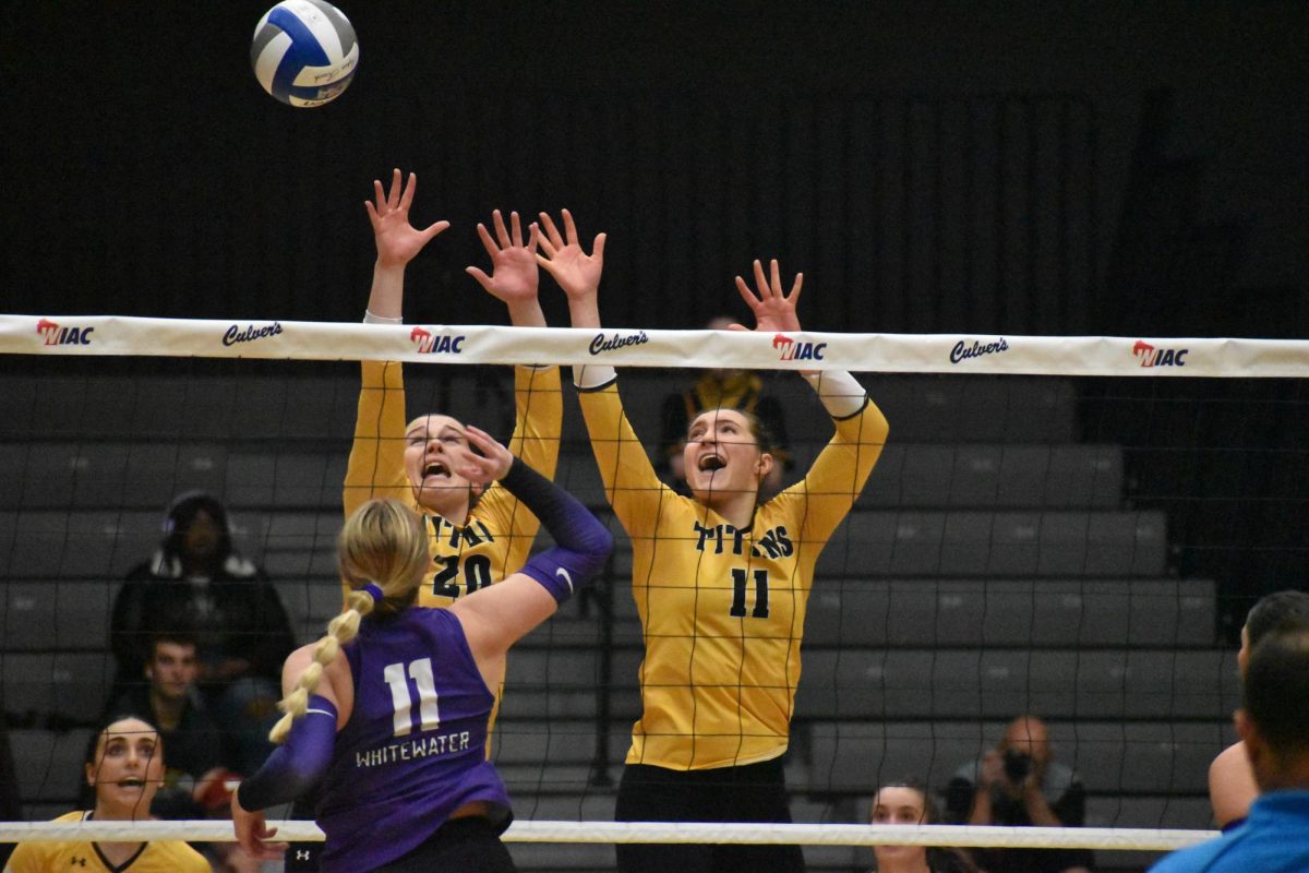 UWO’s Olivia Breunig (20) and Riley Kindt (11) go up to block a UW-Whitewater kill attempt in the WIAC Championship on Nov. 16