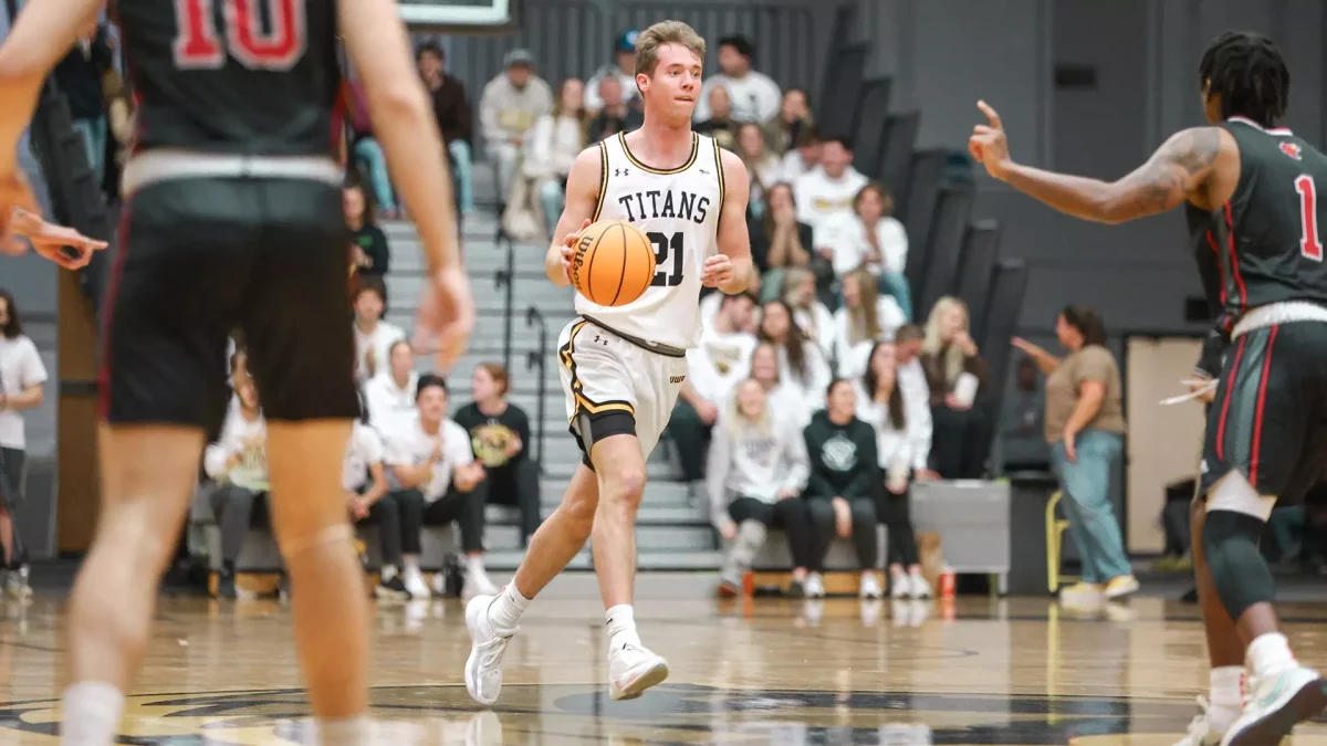 UWO guard Carter Thomas (21) dribbles down the court during a home game at the Kolf Sports Center last season.